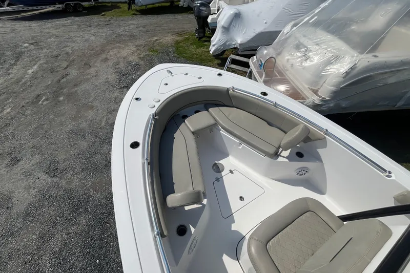 Slide: The Image of 2022 Sportsman Open 242 Center Console boat with cushioned seating and storage compartments. - 10