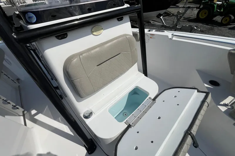 Slide: The Image of 2022 Sportsman Open 242 Center Console boat interior with seating and storage compartment. - 11