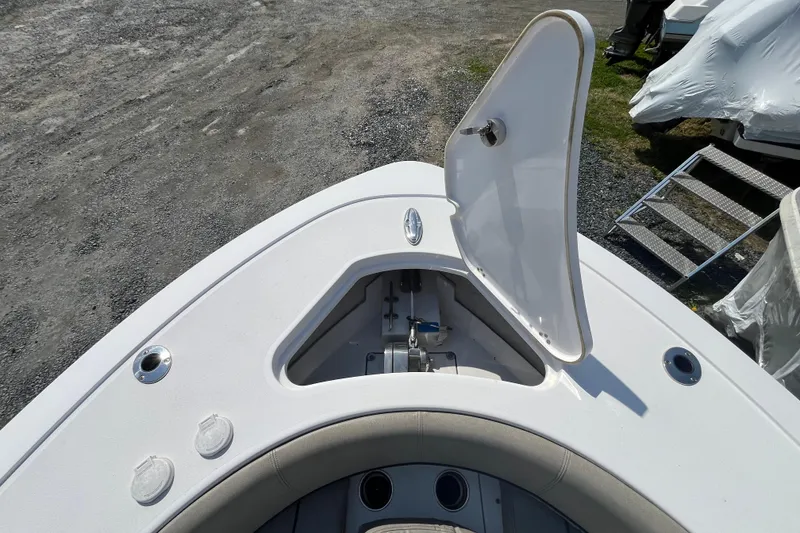 Slide: The Image of 2022 Sportsman Open 242 Center Console boat with open storage compartment on deck. - 12