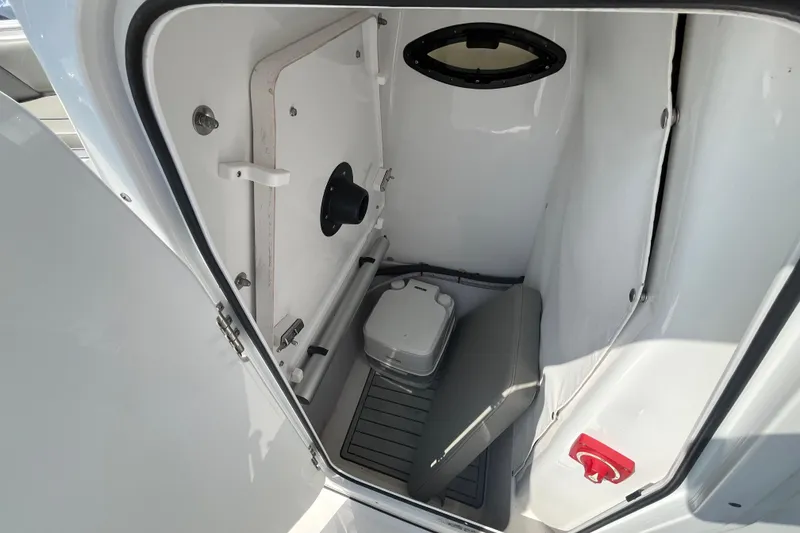 Slide: The Image of Interior of 2022 Sportsman Open 242 Center Console boat, featuring storage compartment. - 13