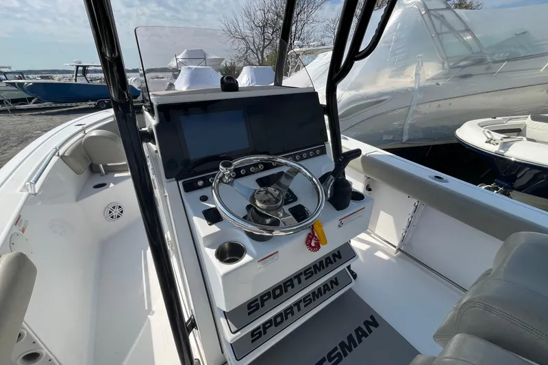 Slide: The Image of 2022 Sportsman Open 242 Center Console boat interior with steering wheel and controls. - 15