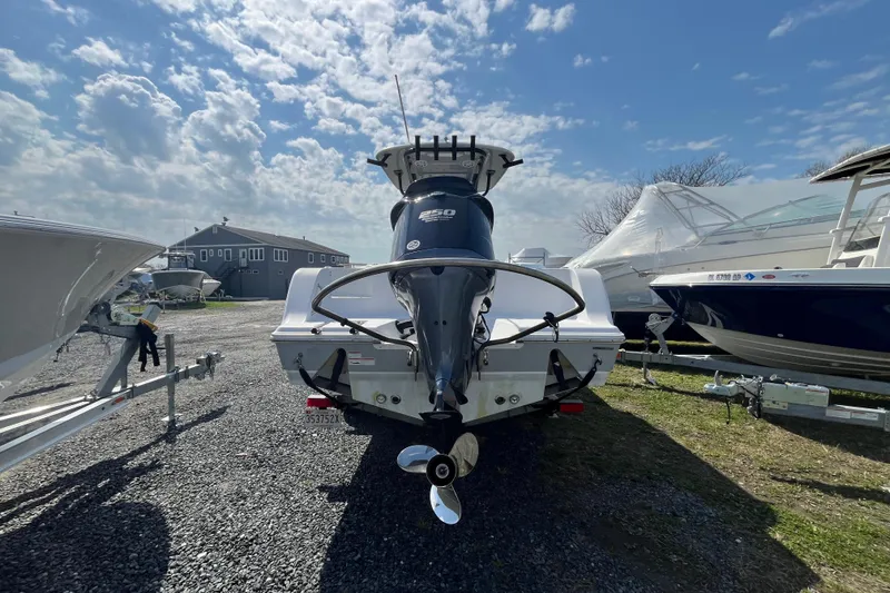 Slide: The Image of 2022 Sportsman Open 242 Center Console boat on trailer under a cloudy sky. - 5