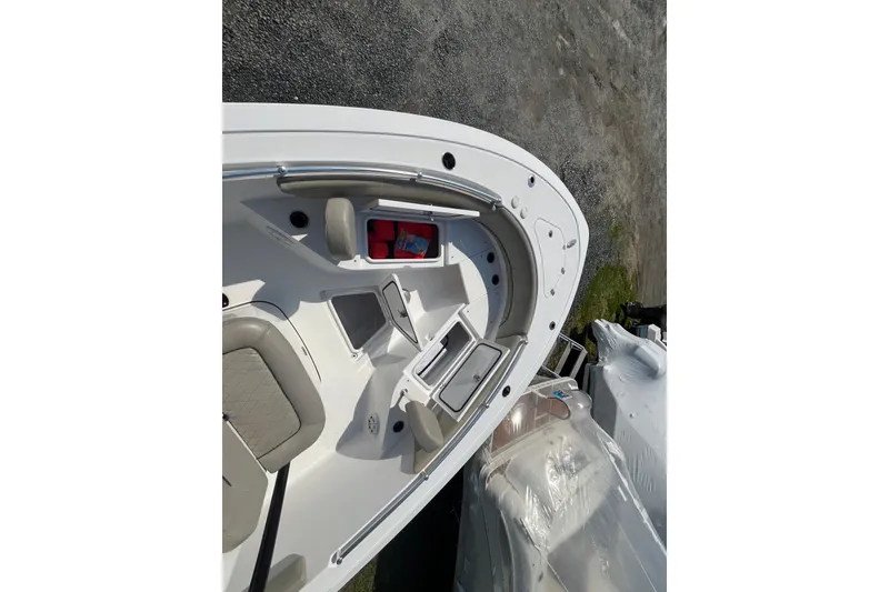 Slide: The Image of 2022 Sportsman Open 242 Center Console boat interior with seating and storage compartments. - 9
