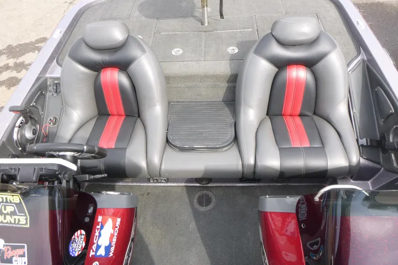 Slide: The Image of 2010 Ranger Z521 boat interior with dual black and red seats. - 10