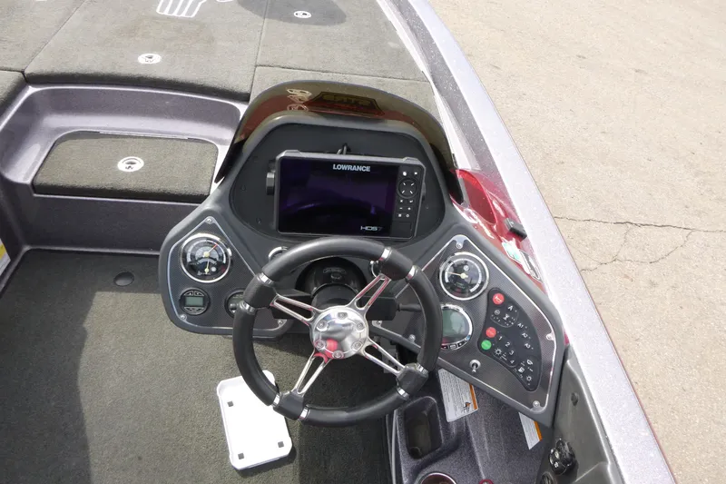 Slide: The Image of 2010 Ranger Z521 boat dashboard with steering wheel and Lowrance fishfinder display. - 12