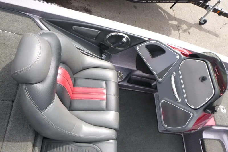 Slide: The Image of 2010 Ranger Z521 boat interior with gray and red seating and dashboard. - 13