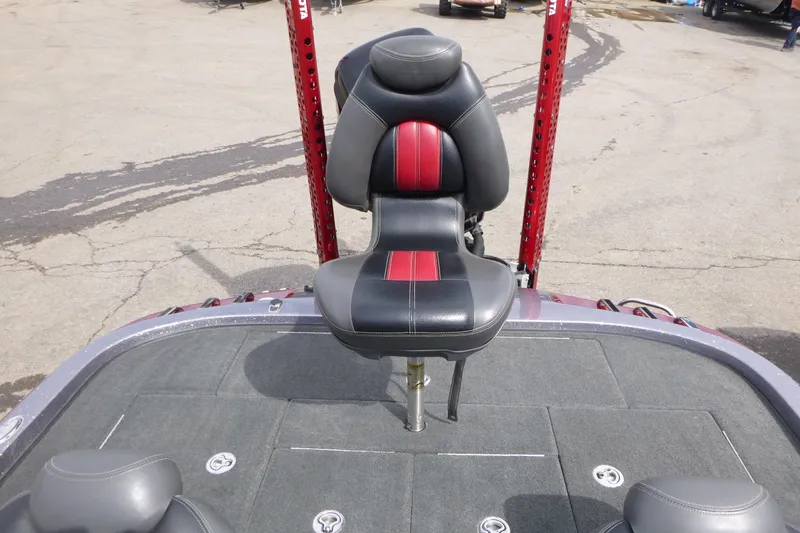 Slide: The Image of 2010 Ranger Z521 boat seat with red and black upholstery on a gray deck. - 15