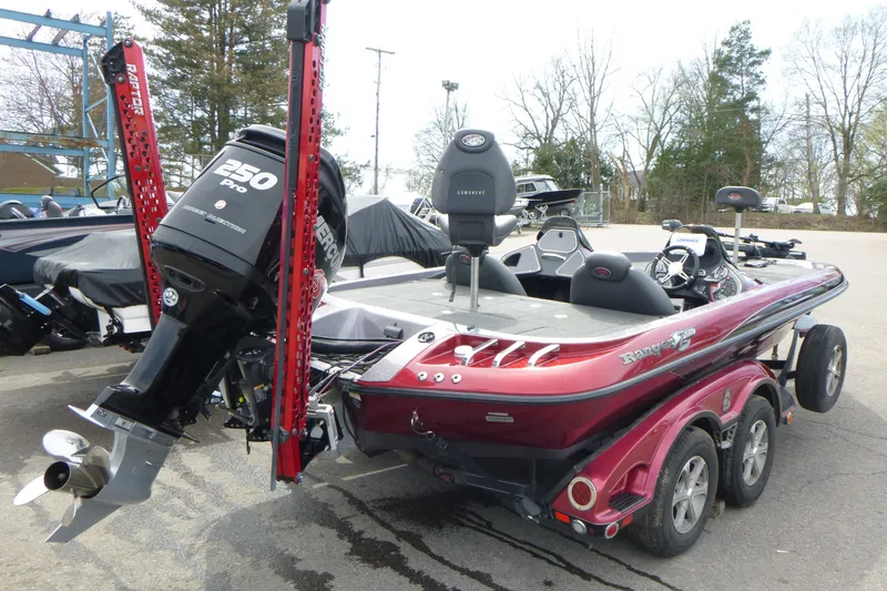 Slide: The Image of 2010 Ranger Z521 boat with Mercury 250 Pro XS engine, parked outdoors. - 2