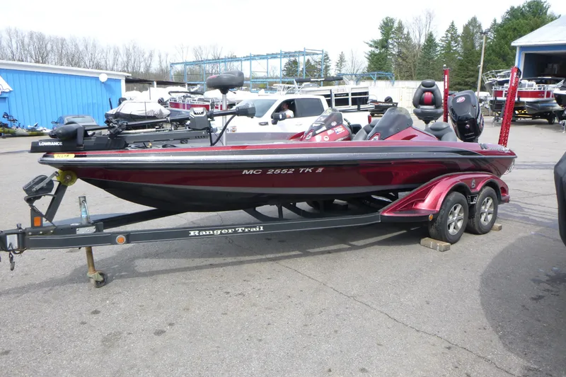 Slide: The Image of 2010 Ranger Z521 bass boat on trailer, parked outdoors near blue building. - 4