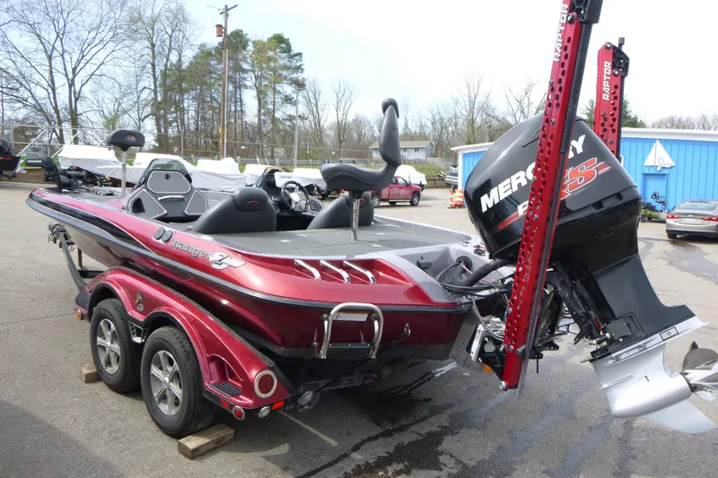 Slide: The Image of 2010 Ranger Z521 boat with Mercury engine, parked outdoors on a trailer. - 5