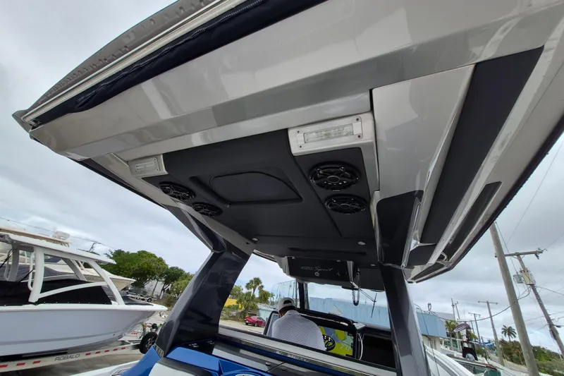 Slide: The Image of 2020 Nor-Tech 450 Sport Center Console boat with sleek overhead design and integrated speakers. - 12