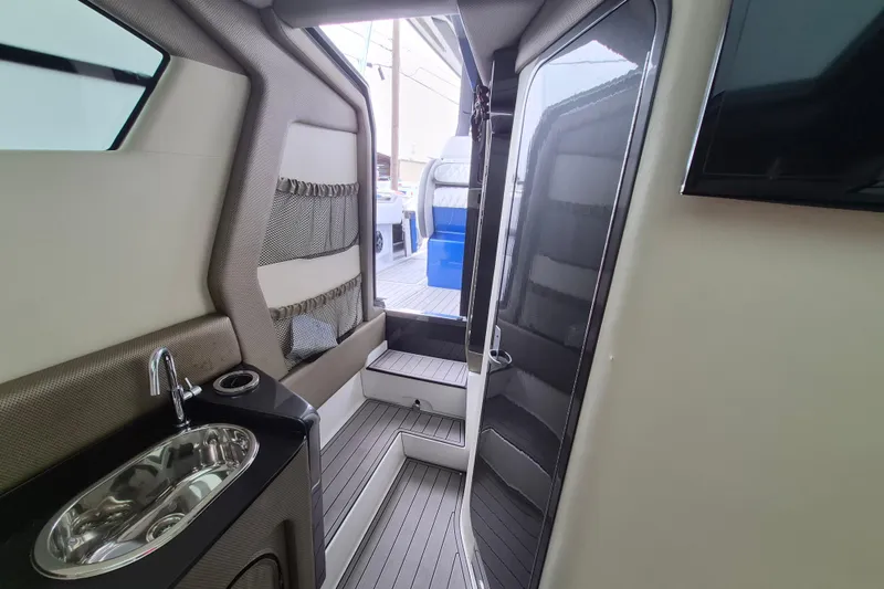 Slide: The Image of Interior of 2020 Nor-Tech 450 Sport Center Console with sink and seating area. - 16