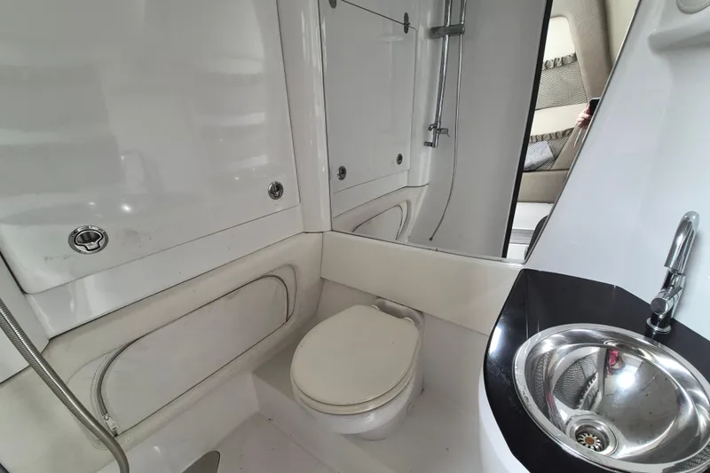 Slide: The Image of 2020 Nor-Tech 450 Sport Center Console bathroom with toilet, sink, and shower. - 18