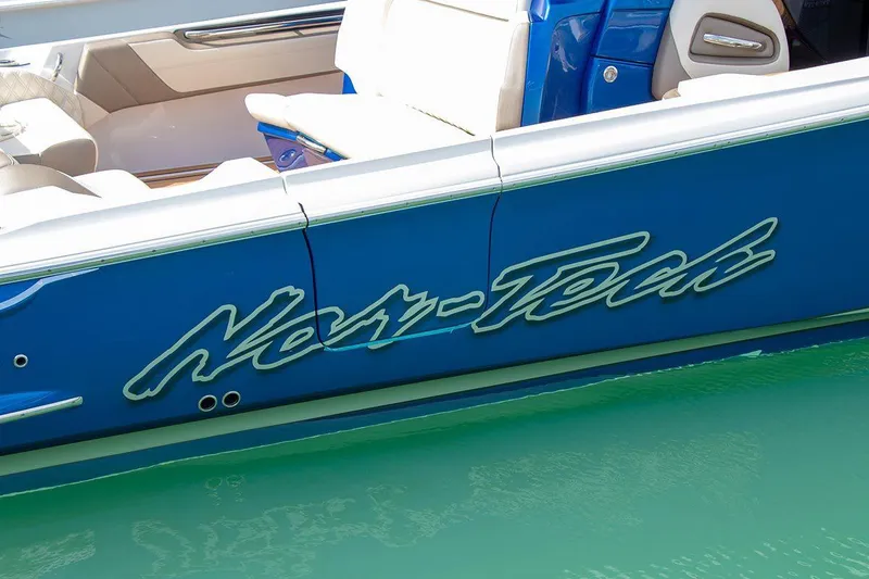 Slide: The Image of Manufacturer Provided Image: 2020 Nor-Tech 450 Sport Center Console boat in blue on water. - 2