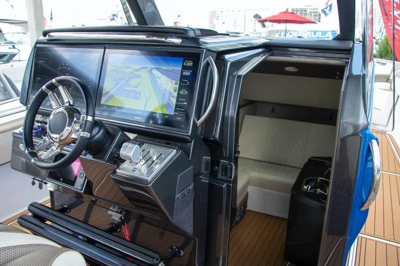 Slide: The Image of Manufacturer Provided Image: 2020 Nor-Tech 450 Sport Center Console helm with navigation display and cabin entrance. - 8