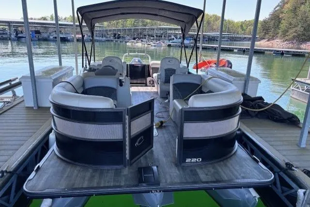 Slide: The Image of 2019 Crest 220 CREST III pontoon boat docked on a serene lake. - 10