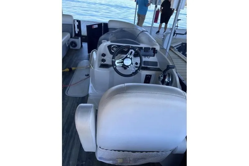 Slide: The Image of 2019 Crest 220 CREST III boat interior with steering wheel and seating. - 12