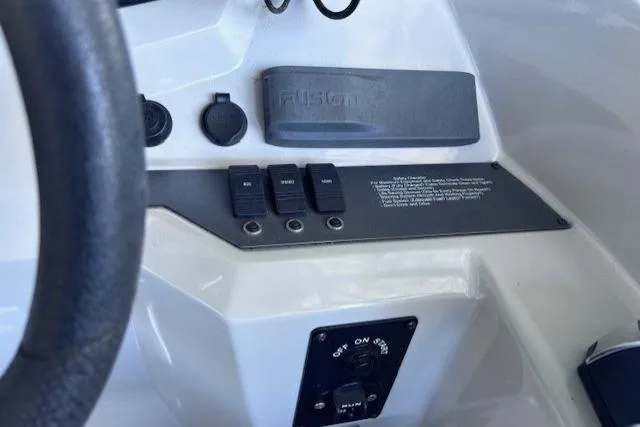Slide: The Image of Control panel of a 2019 Crest 220 CREST III boat with switches and a Fusion audio system. - 14
