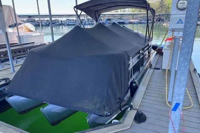 Slide: The Image of 2019 Crest 220 CREST III pontoon boat covered at a marina dock. - 8
