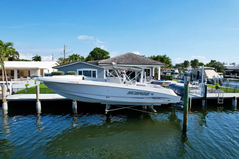 The Image of 2006 Wellcraft 352 Sport boat docked by waterfront home. - 1