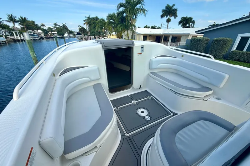 Slide: The Image of 2006 Wellcraft 352 Sport boat interior with seating, docked by waterfront homes. - 14