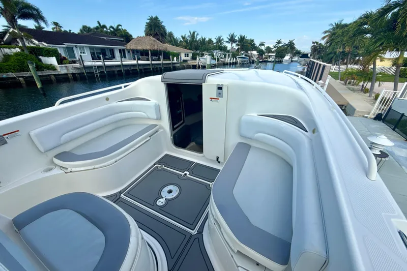 Slide: The Image of 2006 Wellcraft 352 Sport boat interior with seating, docked by waterfront homes. - 15
