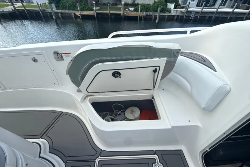 Slide: The Image of 2006 Wellcraft 352 Sport boat storage compartment open, dockside view. - 16