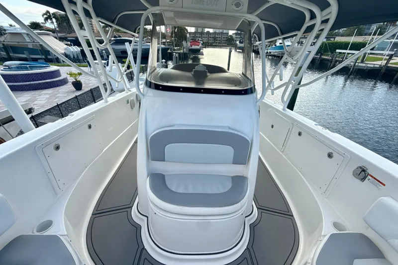 Slide: The Image of 2006 Wellcraft 352 Sport boat interior with seating, docked by the water. - 17