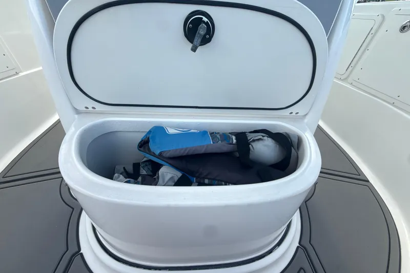 Slide: The Image of Open storage compartment on 2006 Wellcraft 352 Sport boat, containing life jackets. - 18