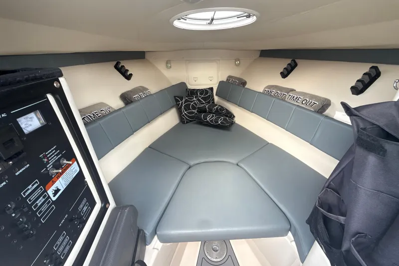 Slide: The Image of Interior cabin of 2006 Wellcraft 352 Sport boat with cushioned seating and control panel. - 21