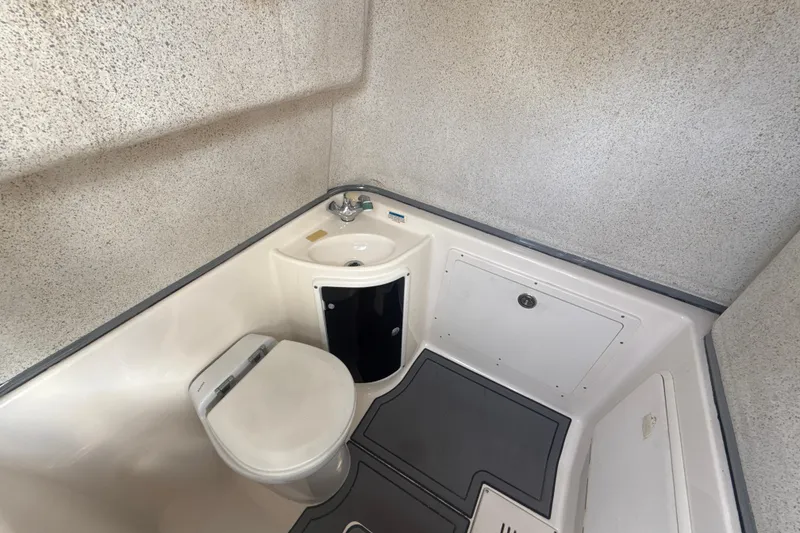 Slide: The Image of Compact bathroom in 2006 Wellcraft 352 Sport boat with toilet and sink. - 24