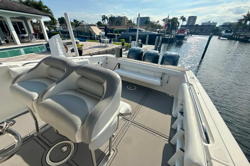 Slide: The Image of 2006 Wellcraft 352 Sport boat interior with seating, docked at marina under sunny skies. - 25