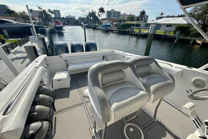 Slide: The Image of 2006 Wellcraft 352 Sport boat interior with seating, docked by waterfront homes. - 26