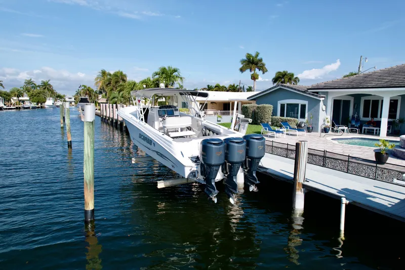 Slide: The Image of 2006 Wellcraft 352 Sport boat docked by waterfront home with palm trees. - 3