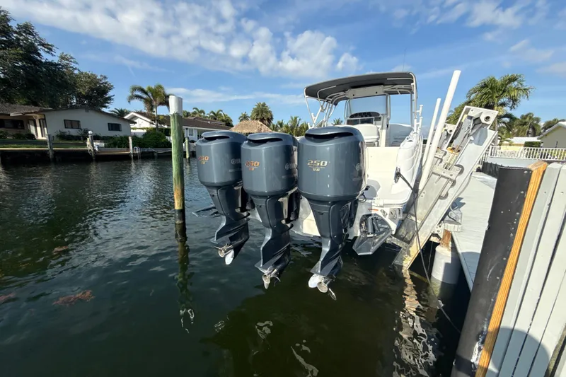 Slide: The Image of 2006 Wellcraft 352 Sport boat with triple Yamaha 250 engines docked by waterfront homes. - 4