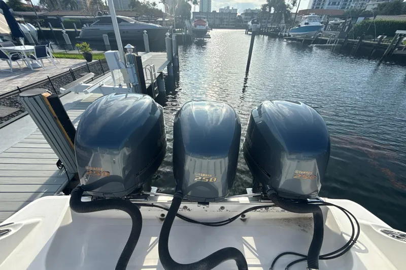 Slide: The Image of Triple Yamaha 250 engines on a 2006 Wellcraft 352 Sport boat docked at a marina. - 5