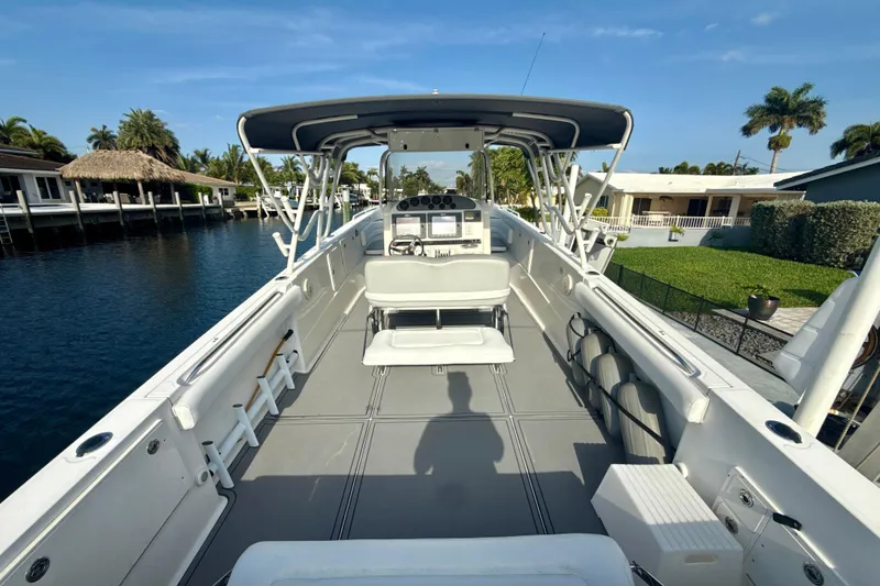 Slide: The Image of 2006 Wellcraft 352 Sport boat with spacious deck, docked by waterfront homes. - 6