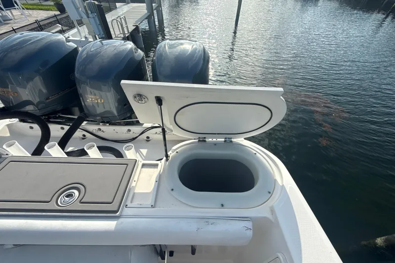 Slide: The Image of 2006 Wellcraft 352 Sport boat with open storage compartment and Yamaha 250 engines. - 9