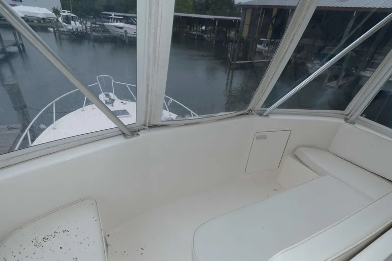 Slide: The Image of 2001 Ocean Yachts 40 Super Sport interior view, showcasing cockpit seating and marina backdrop. - 10