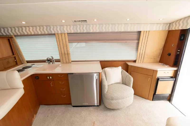 Slide: The Image of Luxurious interior of 2001 Ocean Yachts 40 Super Sport with modern kitchen and cozy seating. - 13