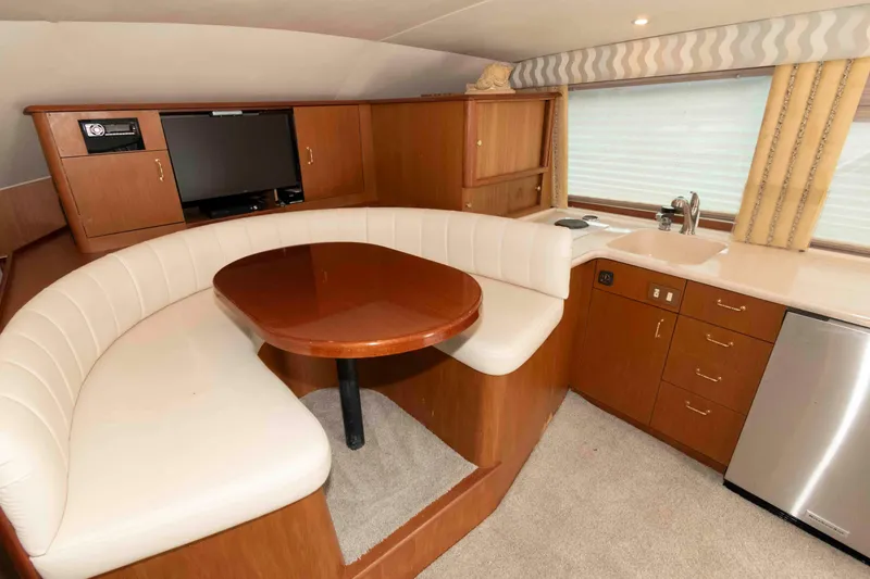 Slide: The Image of Luxurious interior of 2001 Ocean Yachts 40 Super Sport with dining area and kitchenette. - 15