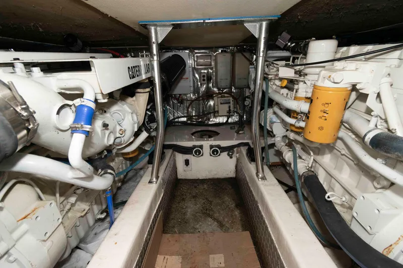 Slide: The Image of Engine room of 2001 Ocean Yachts 40 Super Sport, featuring Caterpillar engines and mechanical components. - 19
