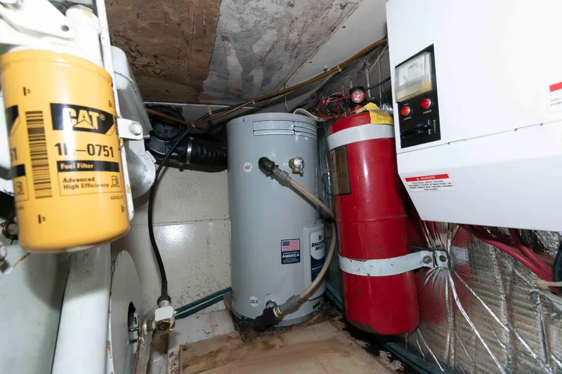 Slide: The Image of Engine room of 2001 Ocean Yachts 40 Super Sport with fuel filter and fire extinguisher. - 22