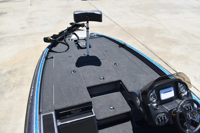 Slide: The Image of 2026 Triton 179 TrX boat interior with advanced dashboard and spacious deck. - 11