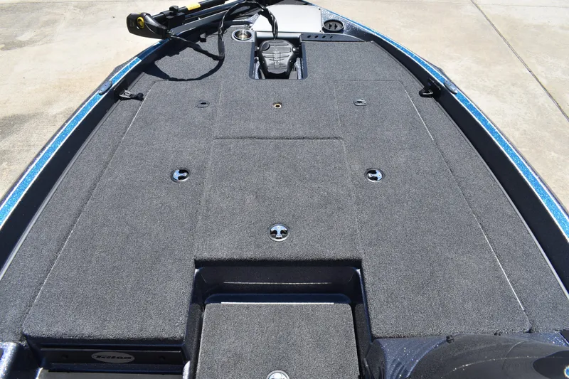 Slide: The Image of 2026 Triton 179 TrX boat deck with carpeted surface and storage compartments. - 12