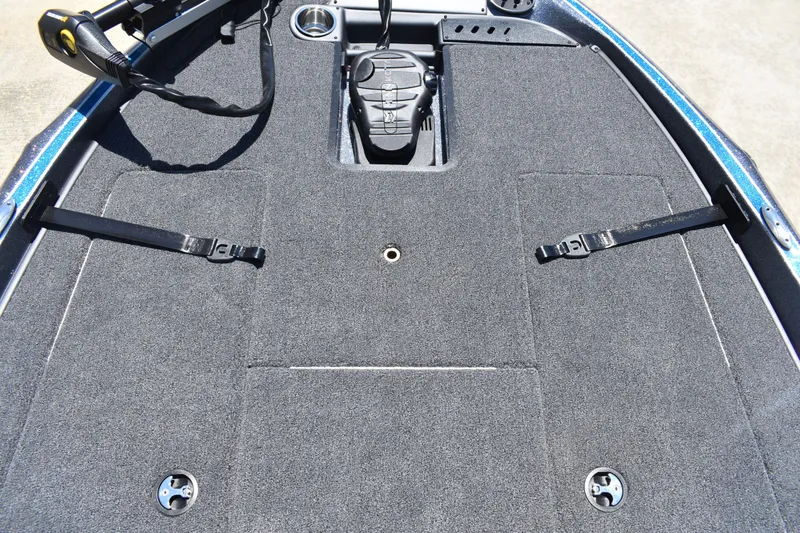 Slide: The Image of 2026 Triton 179 TrX boat deck with carpeted surface and fishing rod holders. - 14