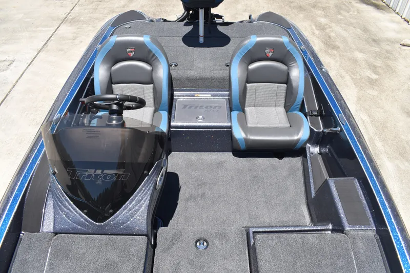 Slide: The Image of 2026 Triton 179 TrX boat interior with dual seats and steering console. - 17