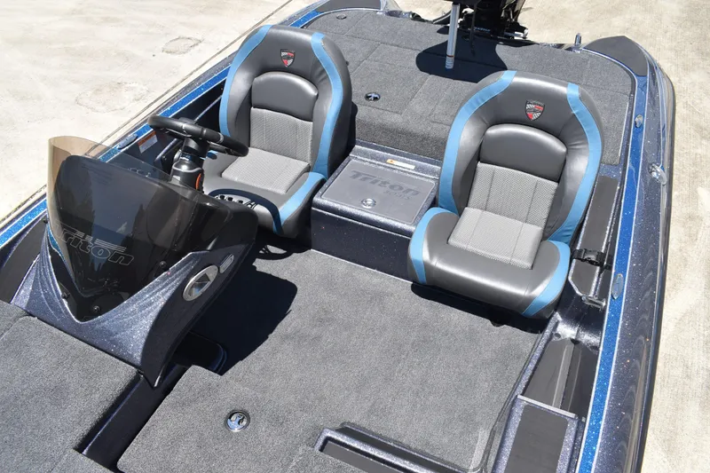 Slide: The Image of 2026 Triton 179 TrX boat interior with dual seats and steering console. - 18