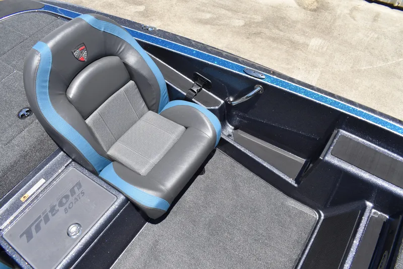Slide: The Image of 2026 Triton 179 TrX boat interior with blue and gray seating, showcasing premium design. - 19