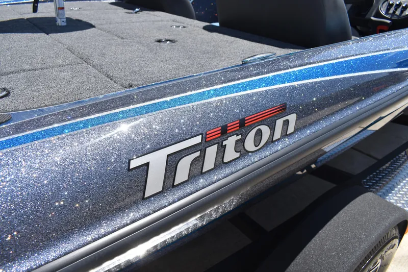 Slide: The Image of 2026 Triton 179 TrX boat with glittery finish and logo detail. - 2